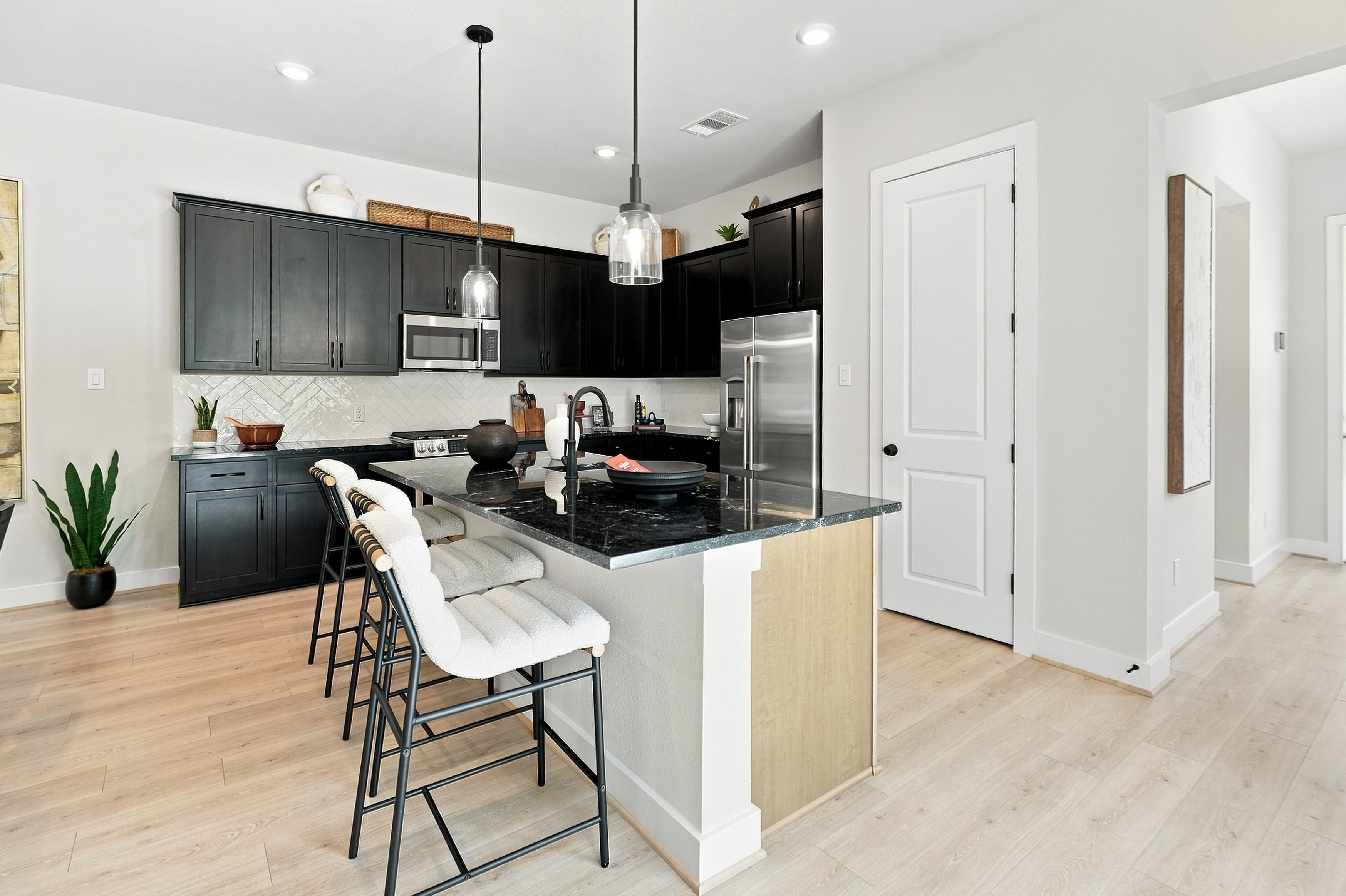Kitchen with dark island — 8102 Yall St